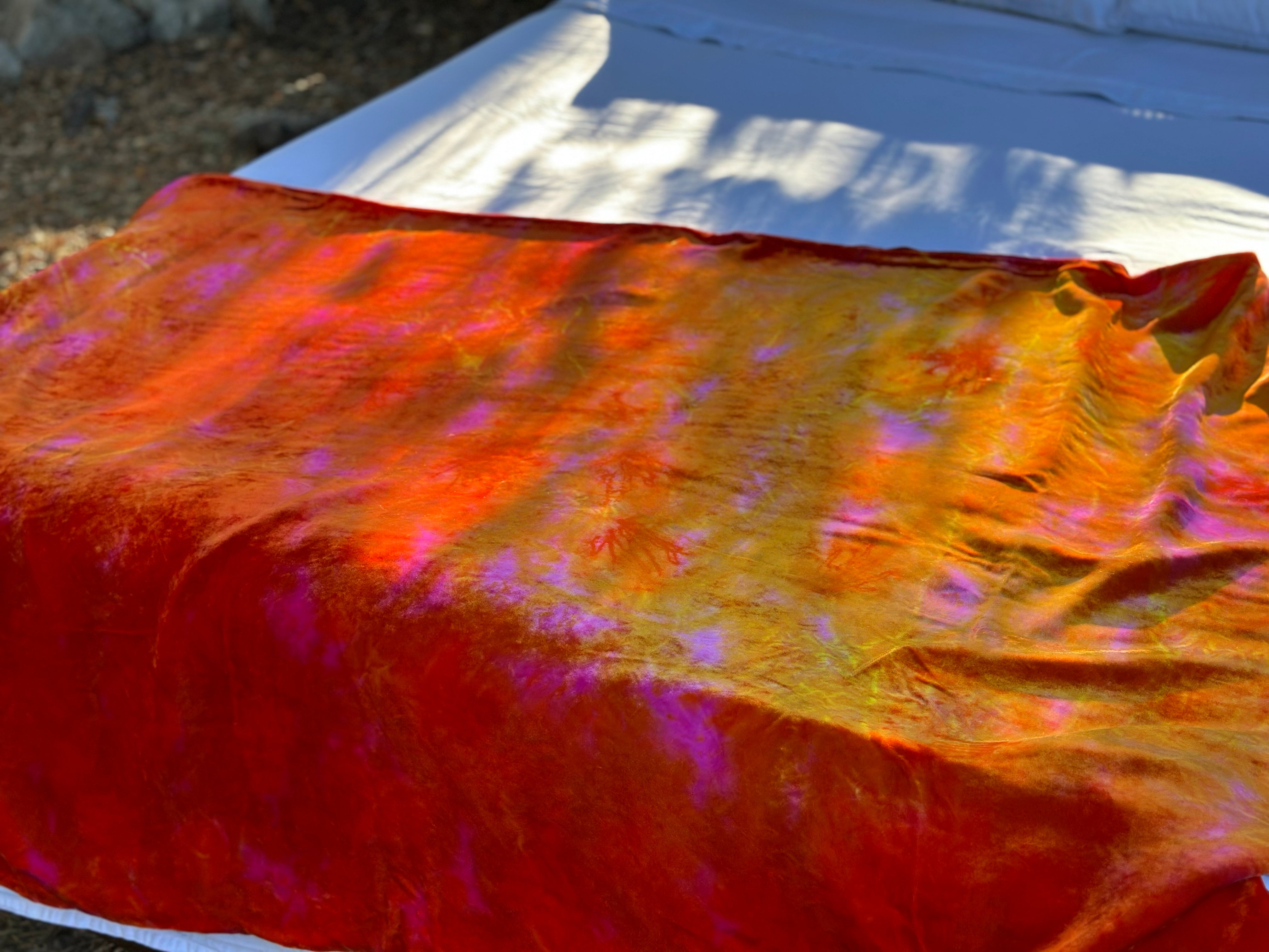 Luxury silk velvet blanket in multicolor tones of red carmine orange fuschia and yellow gold